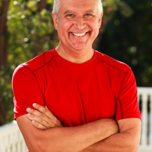Handsome middle age man outdoor portrait with a green background.