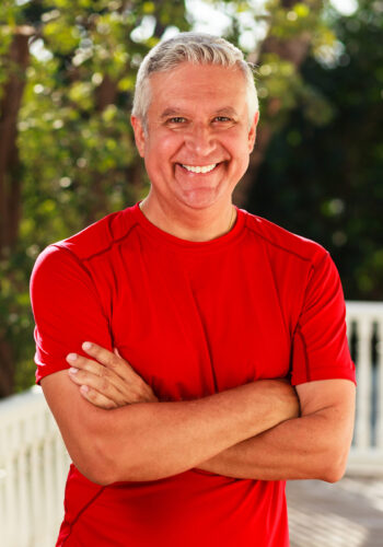 Handsome man Handsome middle age man outdoor portrait with a green background.