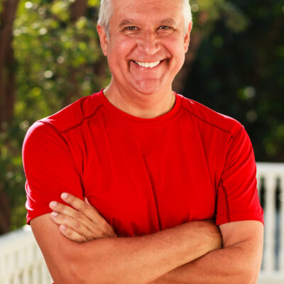 Handsome man Handsome middle age man outdoor portrait with a green background.